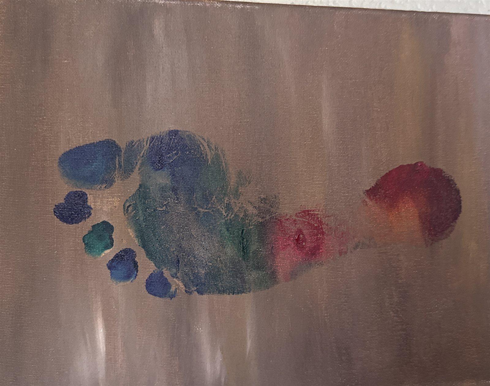 A single footprint in ocean blues and greens stepping across a field of burnished bronze, trailing warmth behind it.